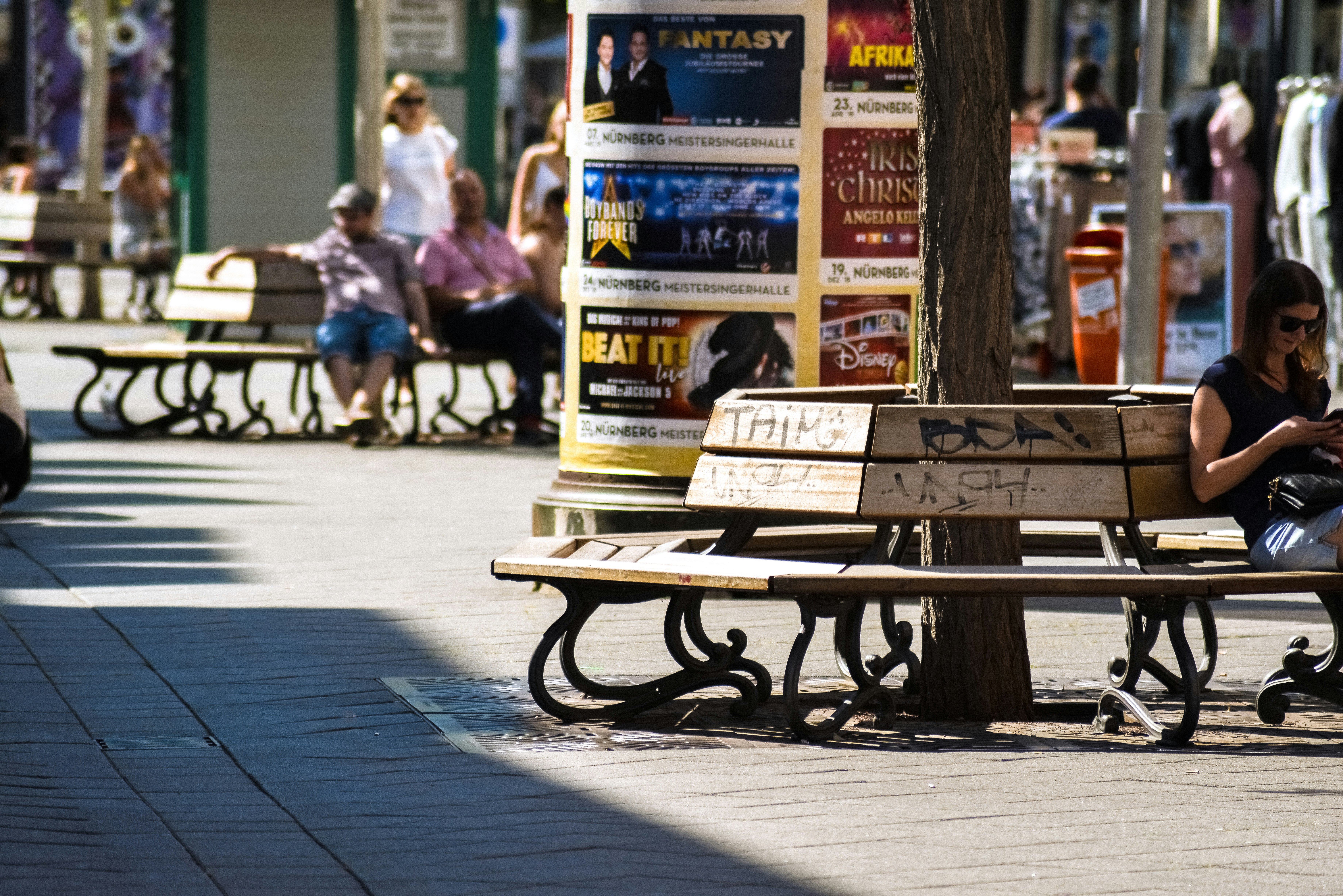 people on street bench during daytime